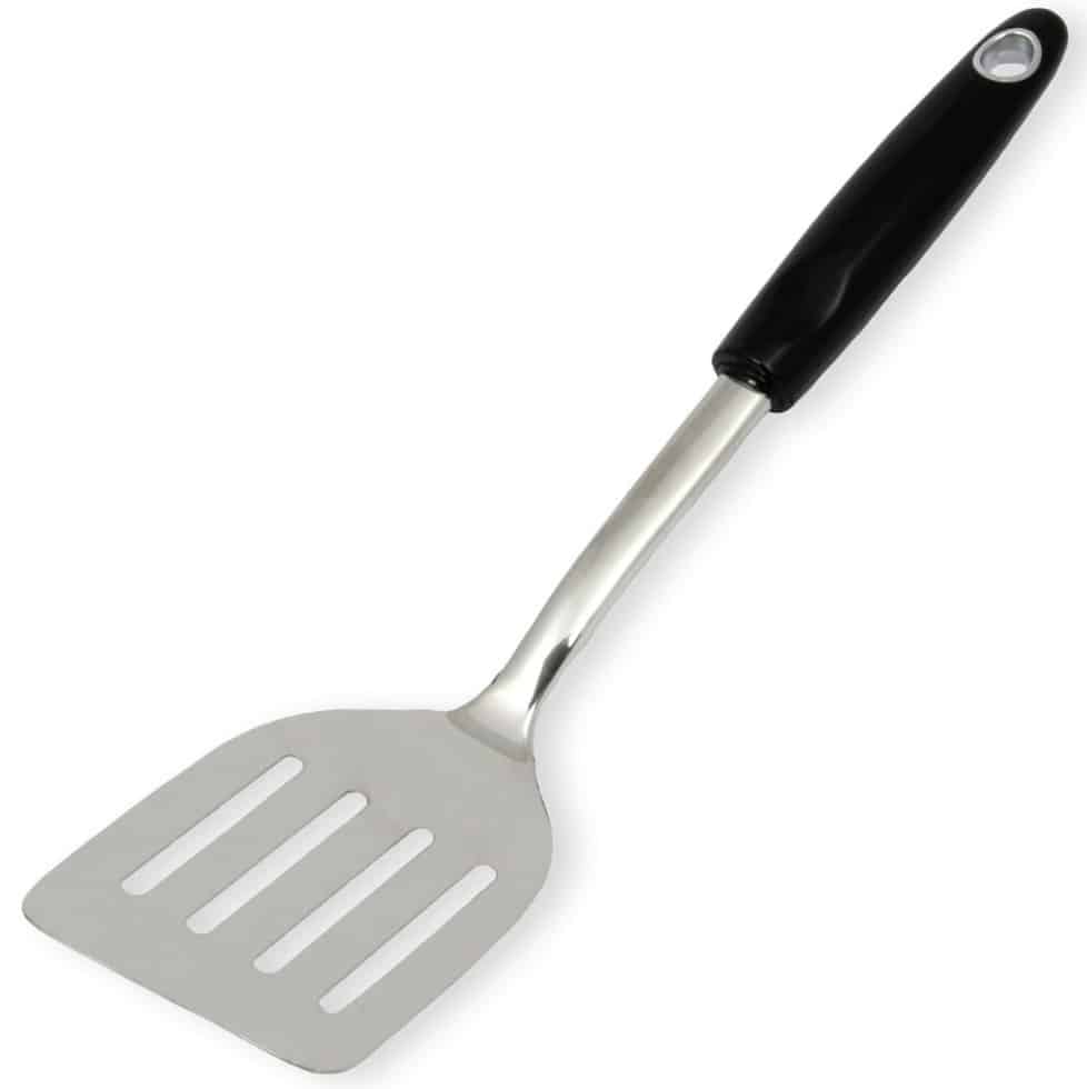 A metal slotted spatula with a black handle and a hole at the end for hanging, perfect for flipping treats like those in your favorite flower cookies recipe, photographed against a white background.